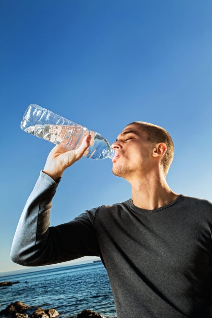 man drinking water for water fasting benefits